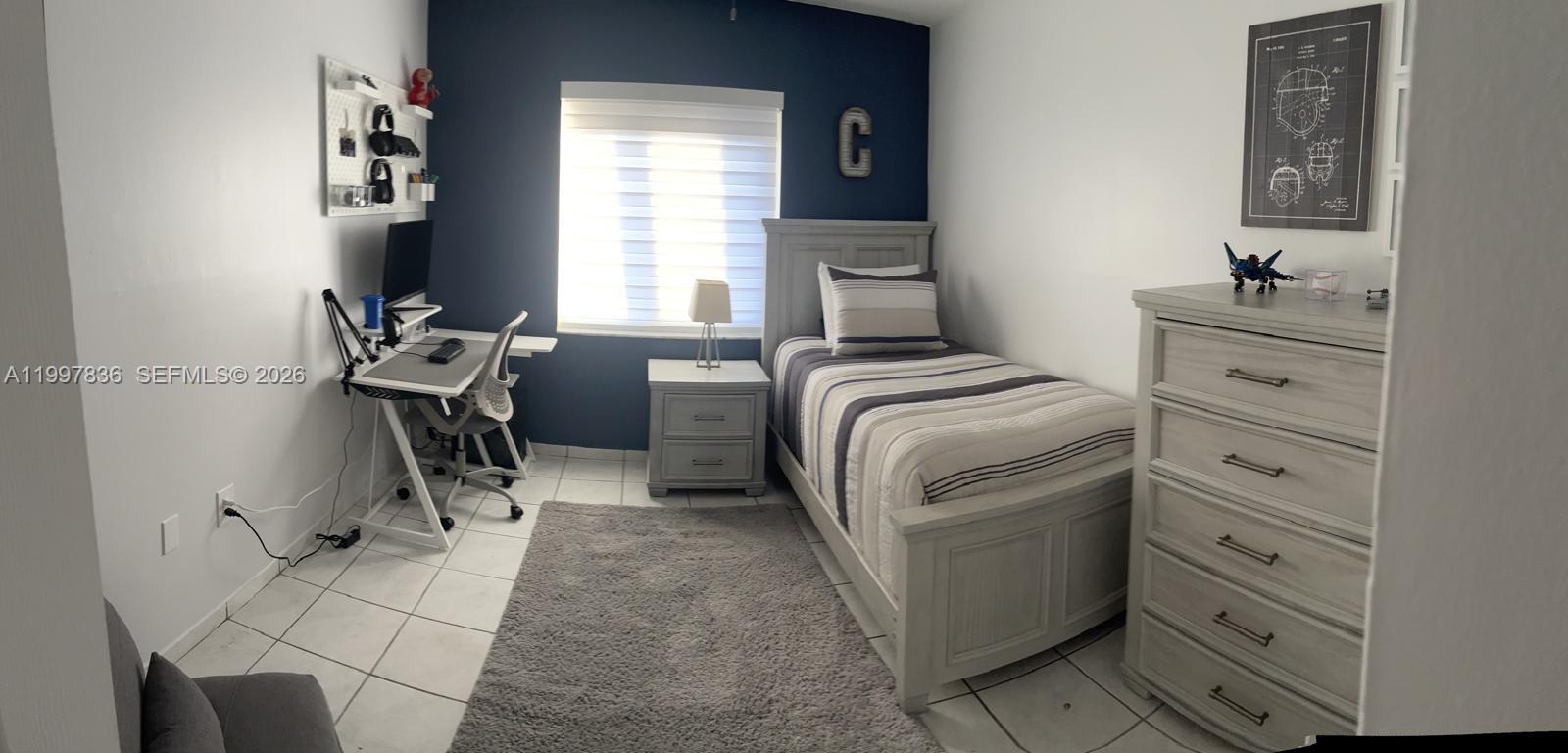 4533 Southwest 143rd Place Miami, FL 33175 - Photo 8 of 12 a bedroom with a bed and a dresser in it