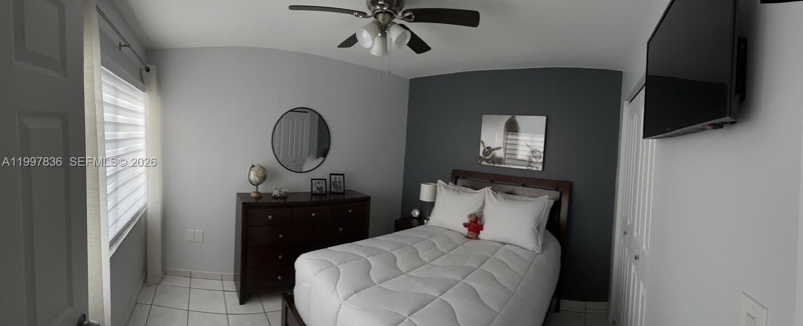 4533 Southwest 143rd Place Miami, FL 33175 - Photo 9 of 12 a living room with furniture and a flat screen tv