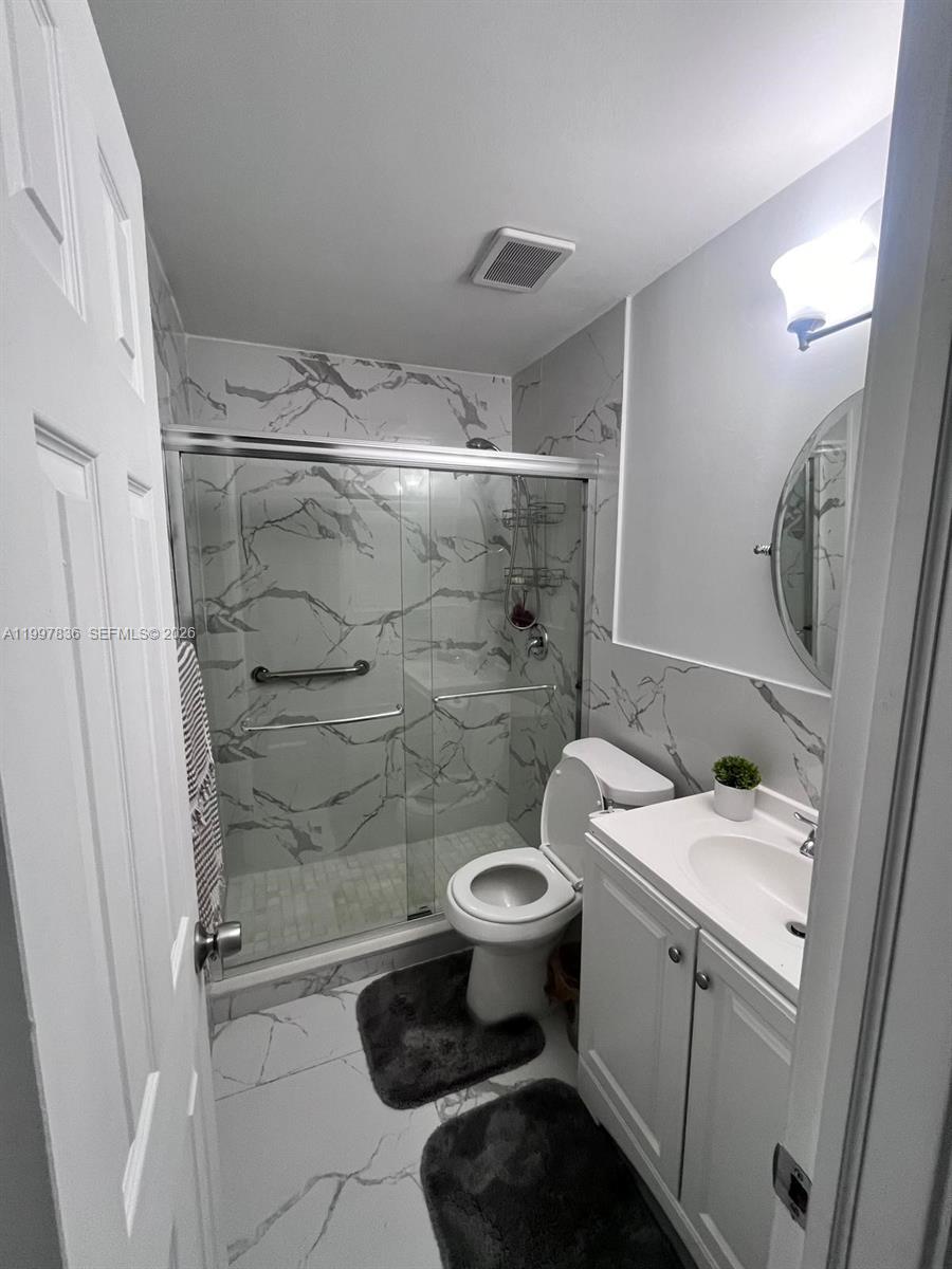 4533 Southwest 143rd Place Miami, FL 33175 - Photo 10 of 12 a bathroom with a sink toilet and shower