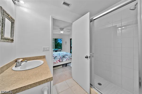 a bathroom with a sink and shower