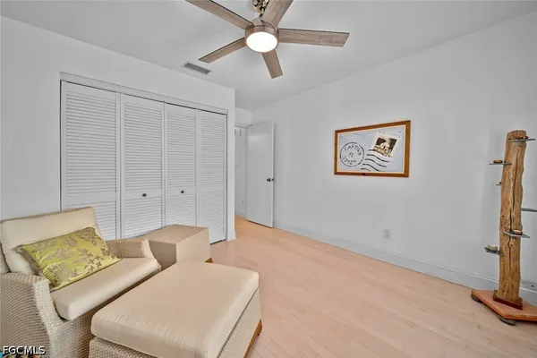 a bedroom with furniture and a ceiling fan