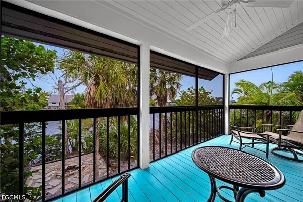 a view of a balcony with furniture and wooden floor