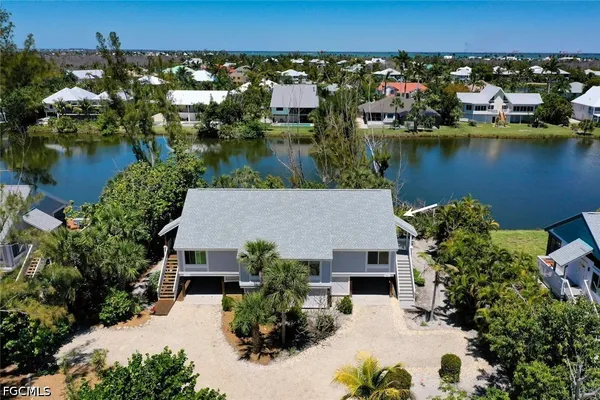 an aerial view of a house with a lake view