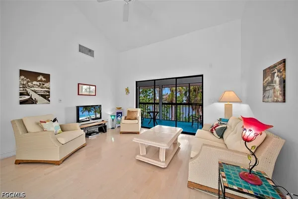 a living room with furniture large window and flat screen tv