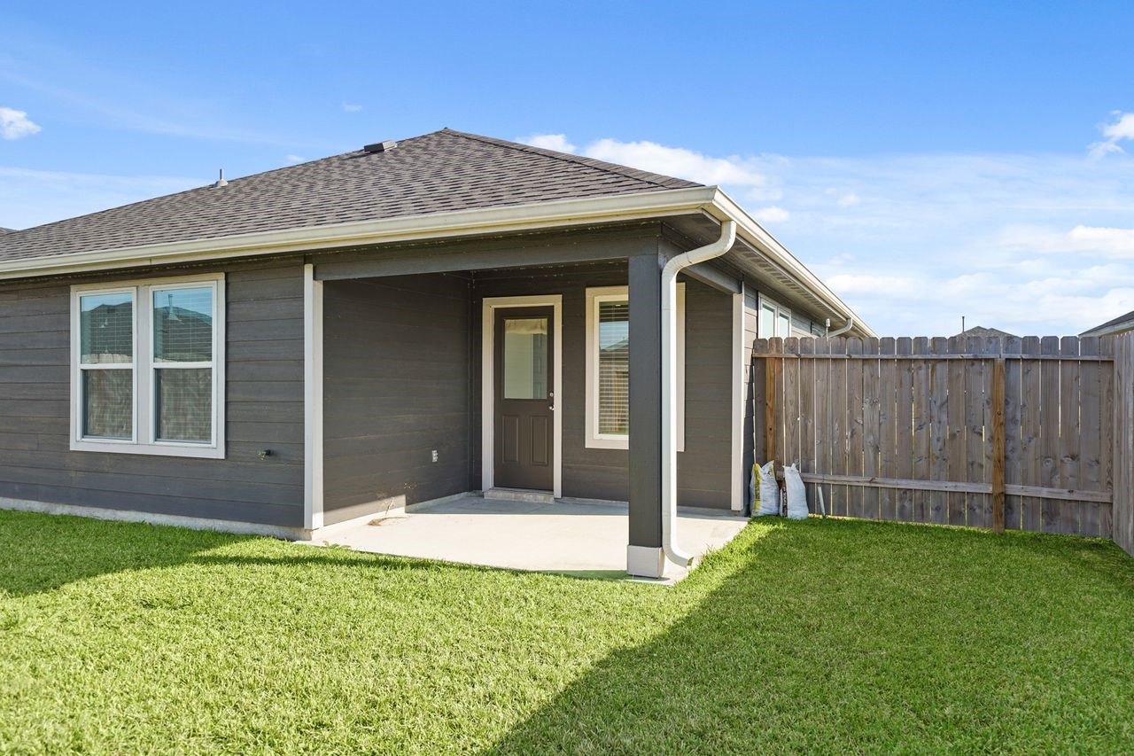 7502 Fierce Friesian Lane Rosharon, TX 77583 - Photo 19 of 21 a front view of a house with a garden