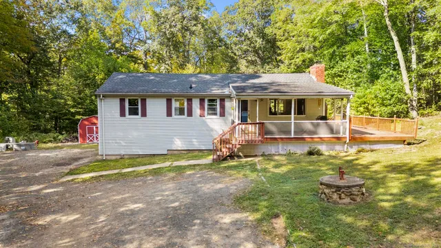 a backyard of a house with yard and outdoor seating
