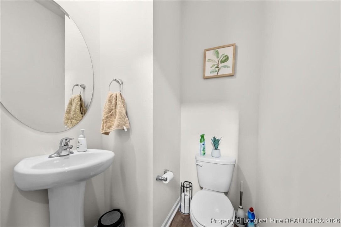 917 Ocean Court Carthage, NC 28327 - Photo 13 of 32 a bathroom with a sink mirror and toilet