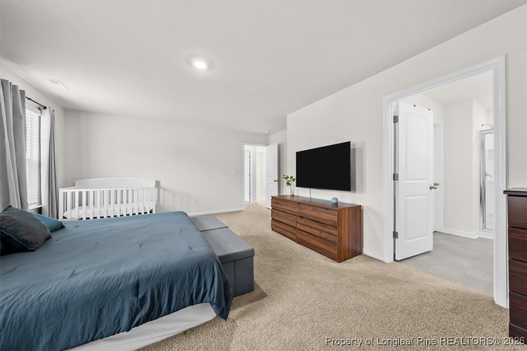 917 Ocean Court Carthage, NC 28327 - Photo 16 of 32 a bedroom with a bed and a flat screen tv