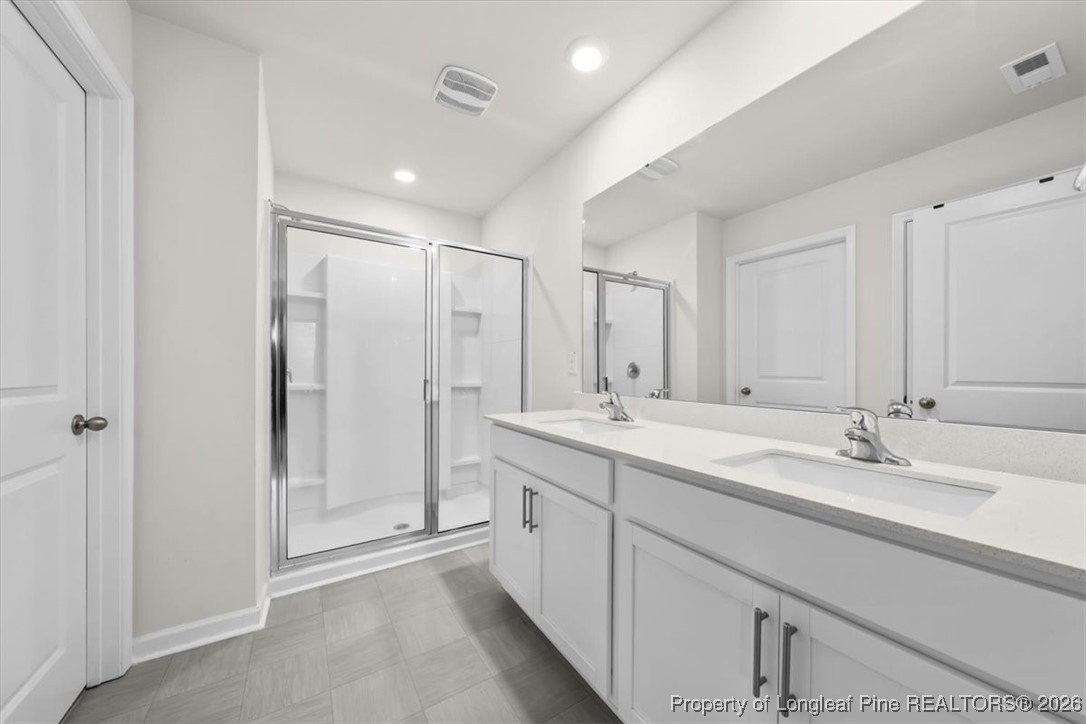 917 Ocean Court Carthage, NC 28327 - Photo 18 of 32 a bathroom with a double vanity sink mirror and double