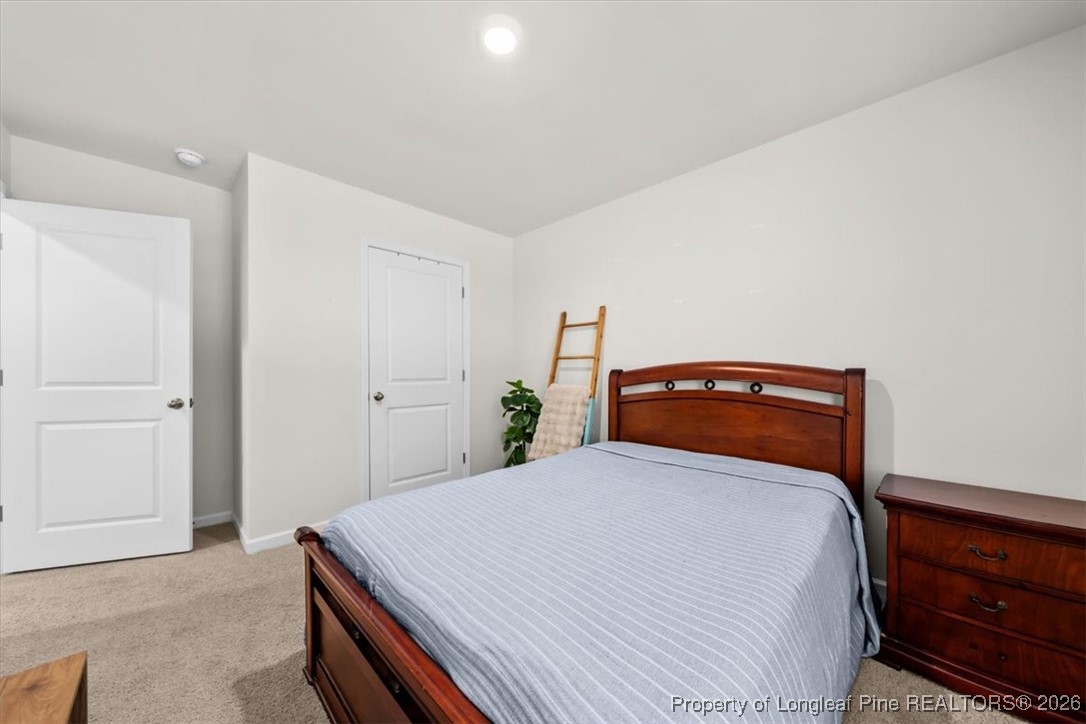 917 Ocean Court Carthage, NC 28327 - Photo 20 of 32 a bedroom with a bed and a dresser