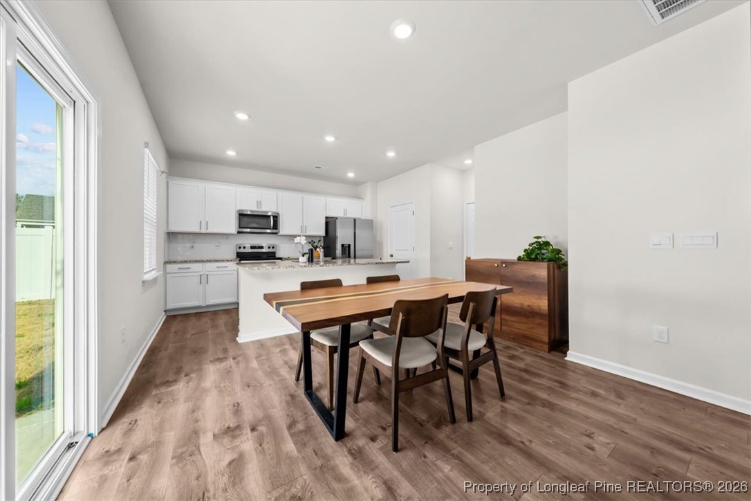 917 Ocean Court Carthage, NC 28327 - Photo 2 of 32 a kitchen with stainless steel appliances kitchen island granite countertop a table chairs sink and cabinets