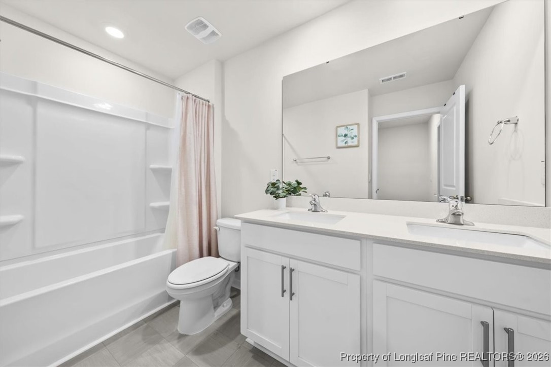 917 Ocean Court Carthage, NC 28327 - Photo 21 of 32 a bathroom with a sink a toilet and a large mirror