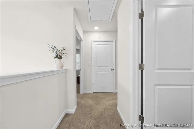 a view of a hallway with wooden shelves