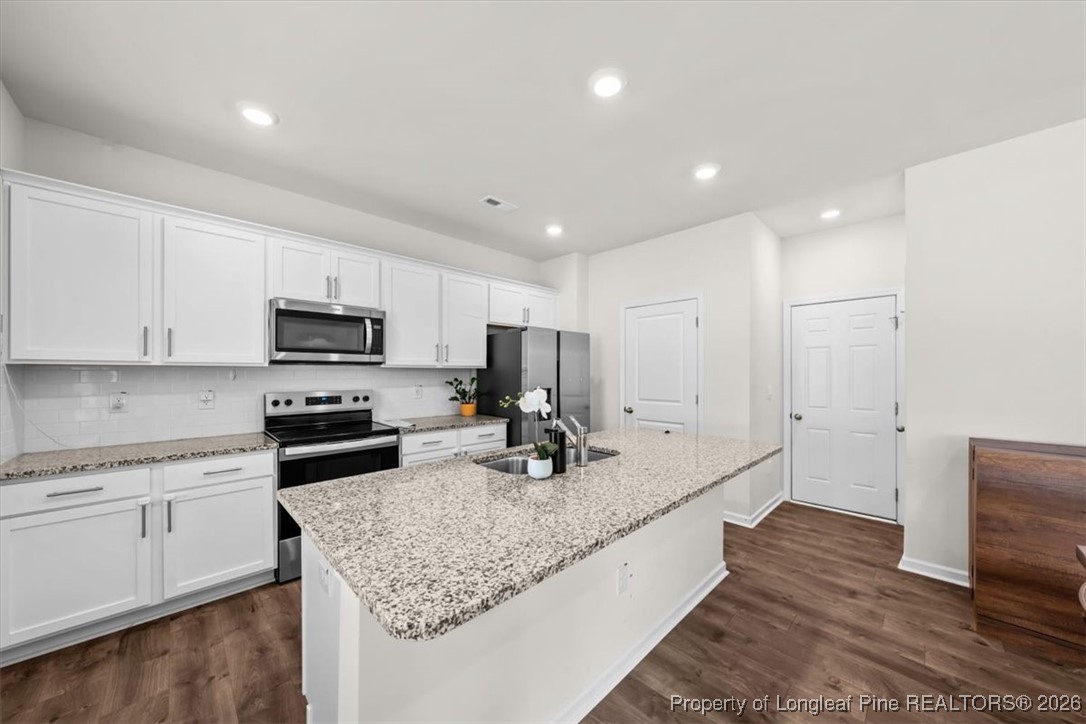 917 Ocean Court Carthage, NC 28327 - Photo 4 of 32 a kitchen with stainless steel appliances granite countertop a sink stove and refrigerator