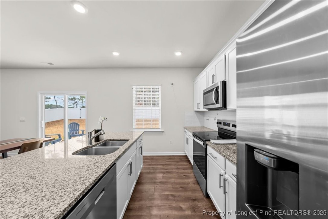917 Ocean Court Carthage, NC 28327 - Photo 6 of 32 a large kitchen with stainless steel appliances granite countertop a sink a stove and a wooden floors
