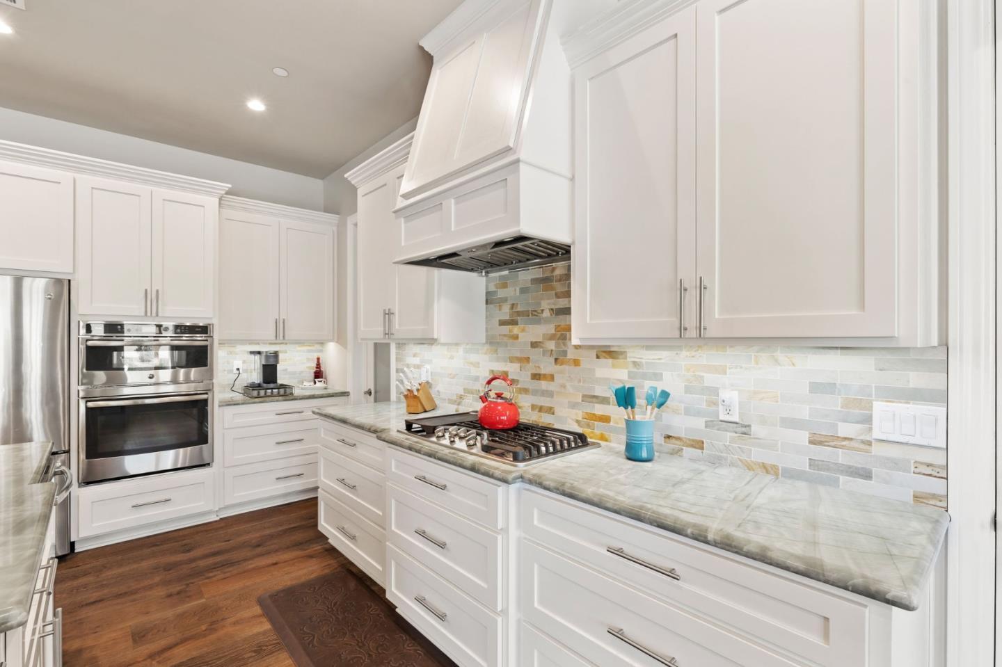 7251 Diablo Hills Road Tres Pinos, CA 95075 - Photo 12 of 60 a kitchen with stainless steel appliances granite countertop white cabinets a stove a sink and dishwasher