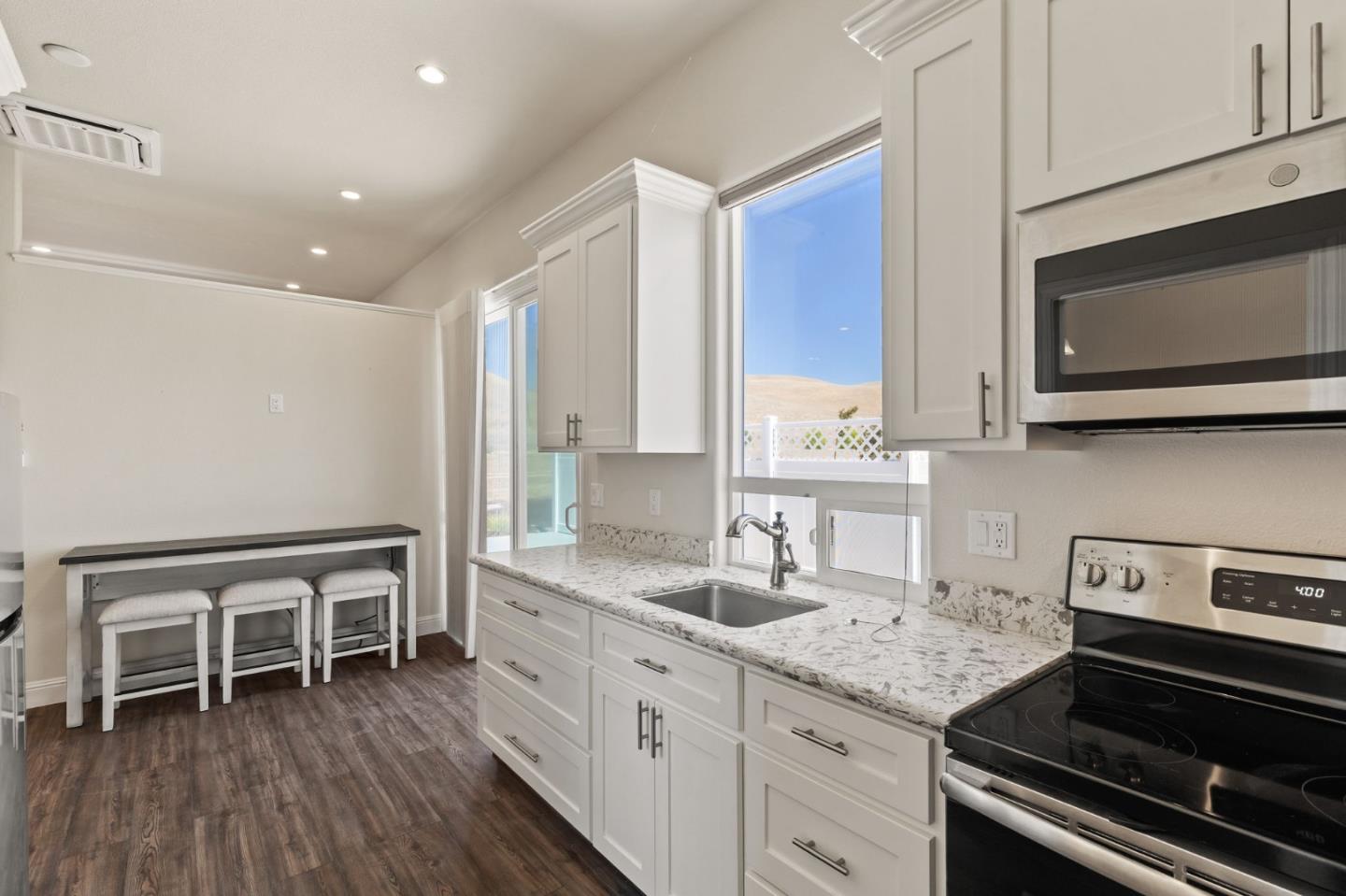7251 Diablo Hills Road Tres Pinos, CA 95075 - Photo 33 of 60 a kitchen with stainless steel appliances granite countertop a stove a sink and a microwave