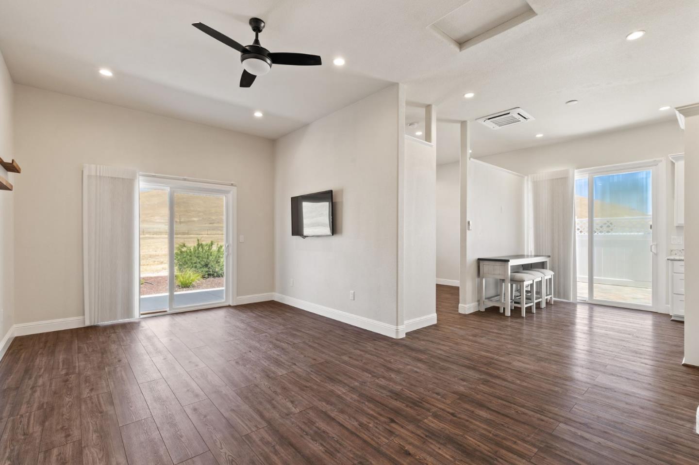 7251 Diablo Hills Road Tres Pinos, CA 95075 - Photo 37 of 60 a view of an empty room with wooden floor and a ceiling fan