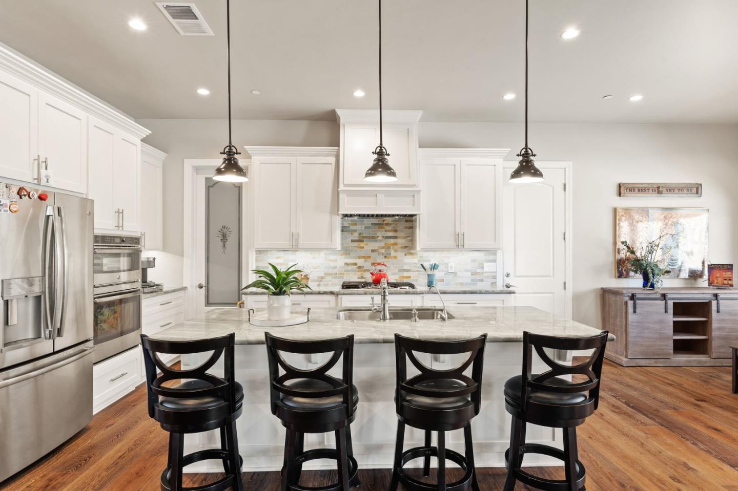 7251 Diablo Hills Road Tres Pinos, CA 95075 - Photo 10 of 60 a kitchen with stainless steel appliances a dining table chairs and wooden floor