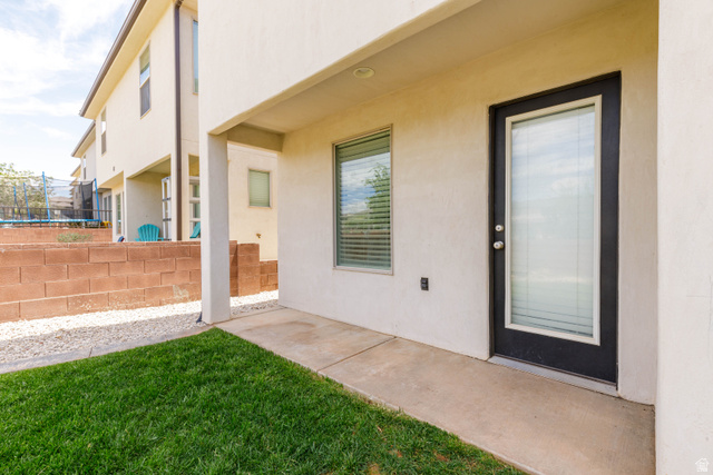 3157 Deseret Drive St. George, UT 84790 - Photo 20 of 24 Covered patio area featuring a concrete slab, stucco exterior, and a full-light exterior door