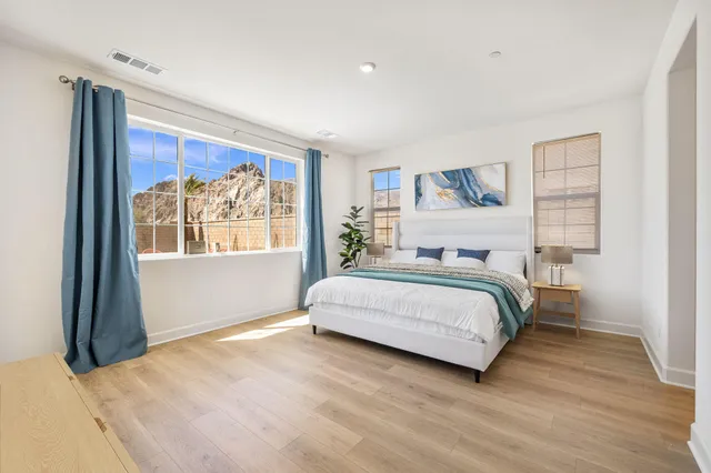 a bedroom with a large bed and a flat screen tv