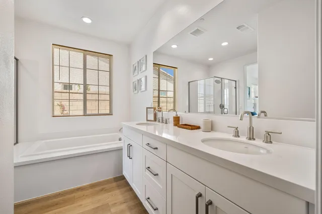 a white bath tub sitting next to a bathroom sink
