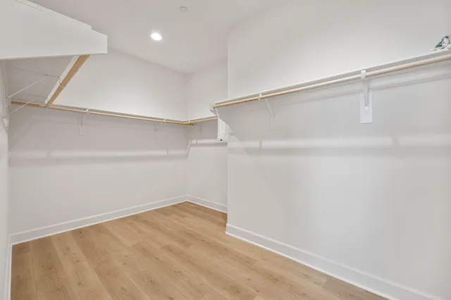 a bedroom with a bed lamp and a window