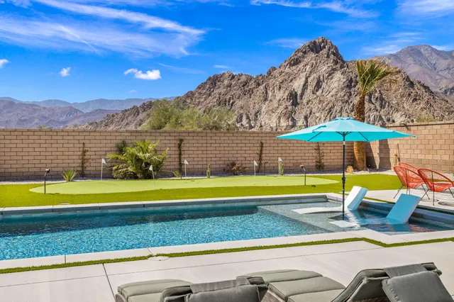 a view of swimming pool with a yard