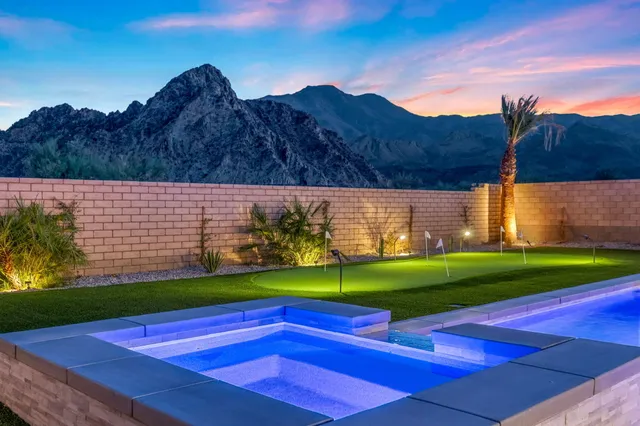 a view of yard with swimming pool and green space