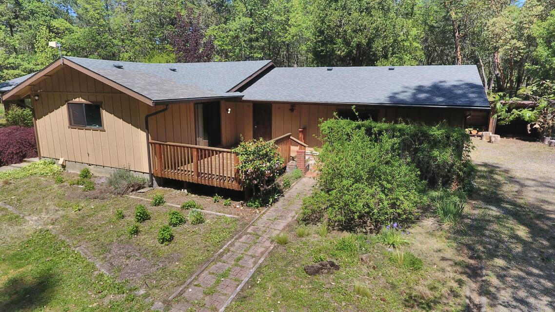922 Garner Road Cave Junction, OR 97523 - Photo 2 of 24 an aerial view of a house with yard and garage