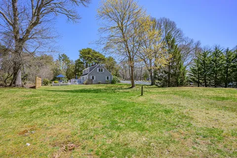 an aerial view of a house with a yard