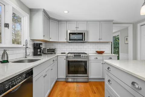 a kitchen with stainless steel appliances a stove sink and cabinets