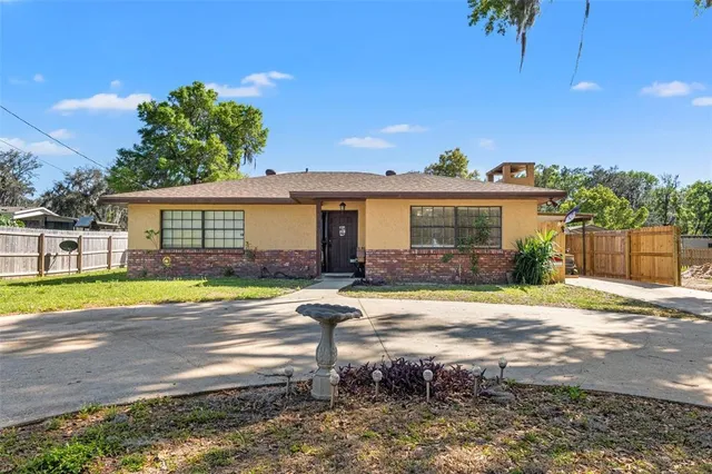 a view of a house with pool and a yard