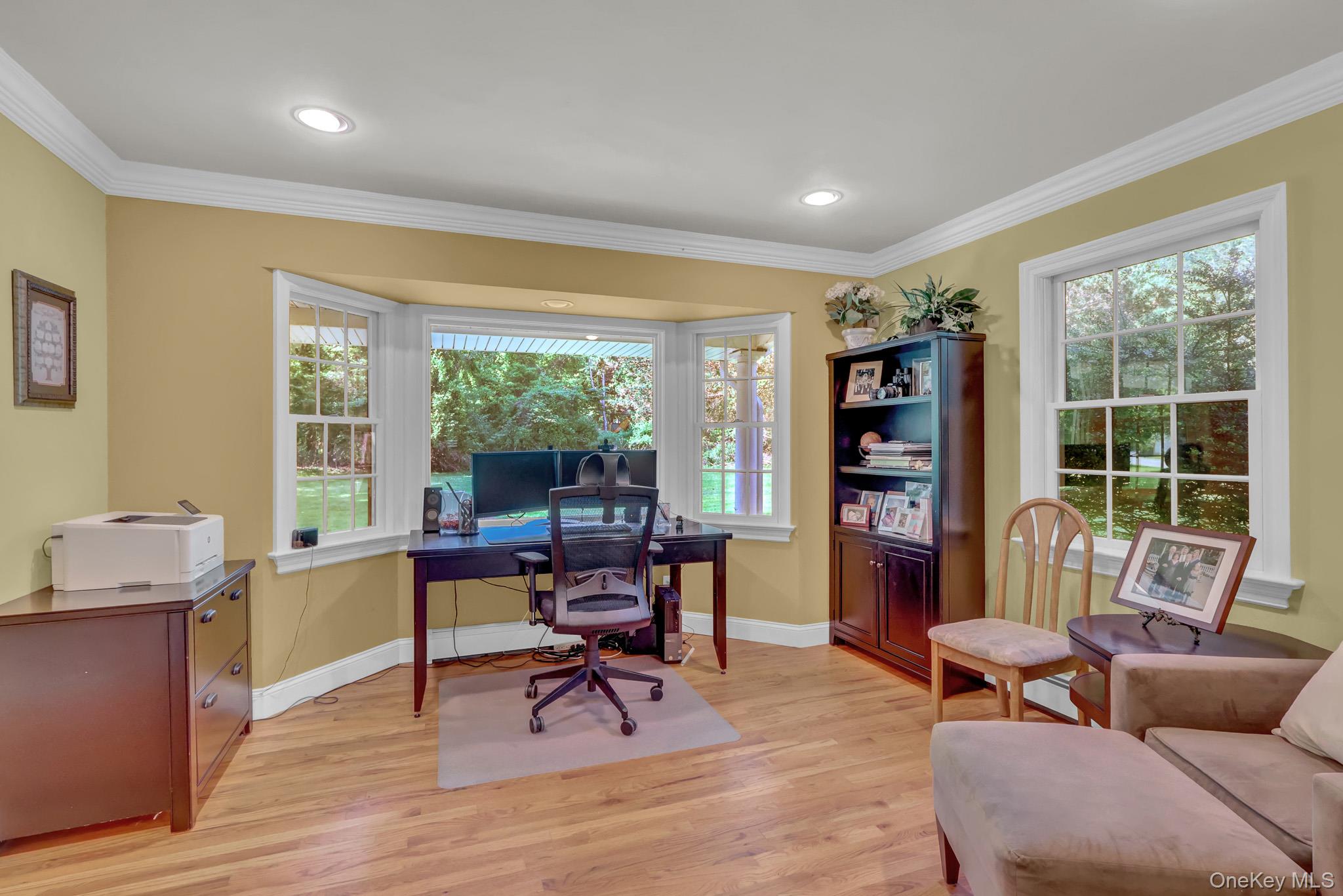 15 Stillwater Road Nissequogue, NY 11780 - Photo 23 of 43 Interior space featuring a prominent bay window, wood-finish flooring, recessed lighting, and white crown molding