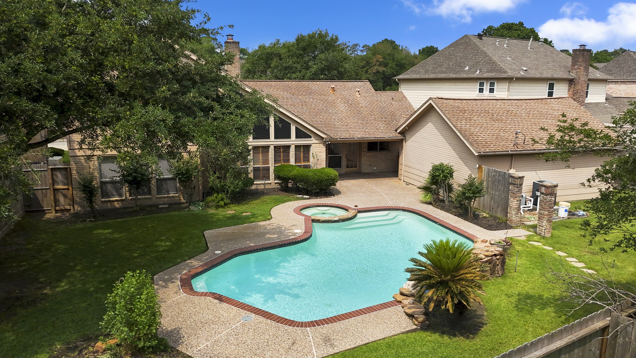 16606 Brendon Court Spring, TX 77379 - Photo 2 of 43 The tranquil backyard features a sparkling pool and spa with rock waterfall, in addition to having plenty of yard space for the kids and pets to play safely in a fully fenced backyard.