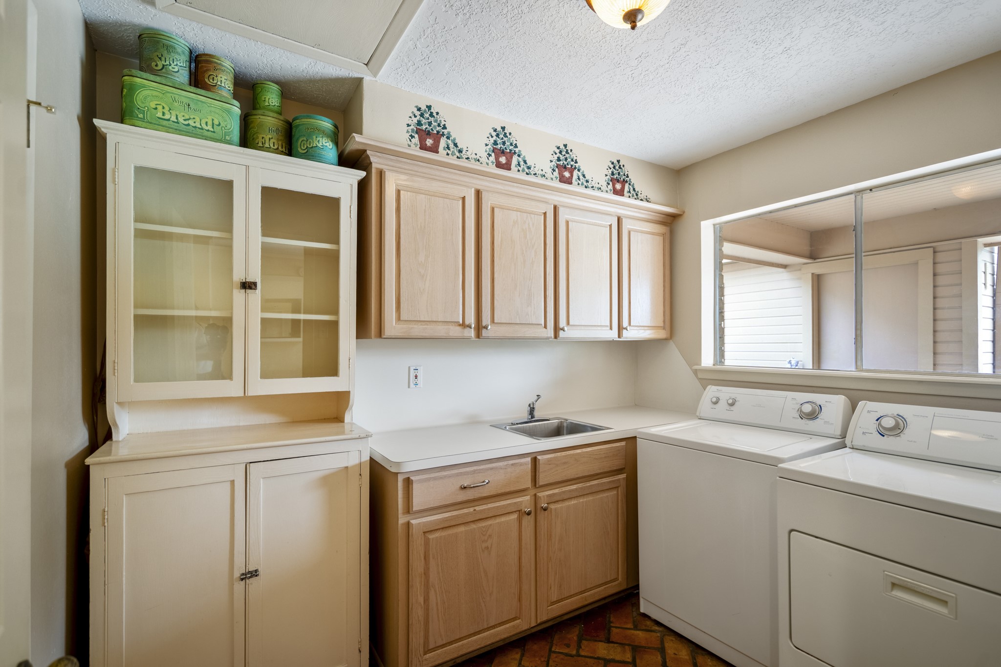 16606 Brendon Court Spring, TX 77379 - Photo 23 of 43 The laundry room has plenty of space with lots of built-ins as well as a hand washing sink, as well as a window that allows for natural lighting.
