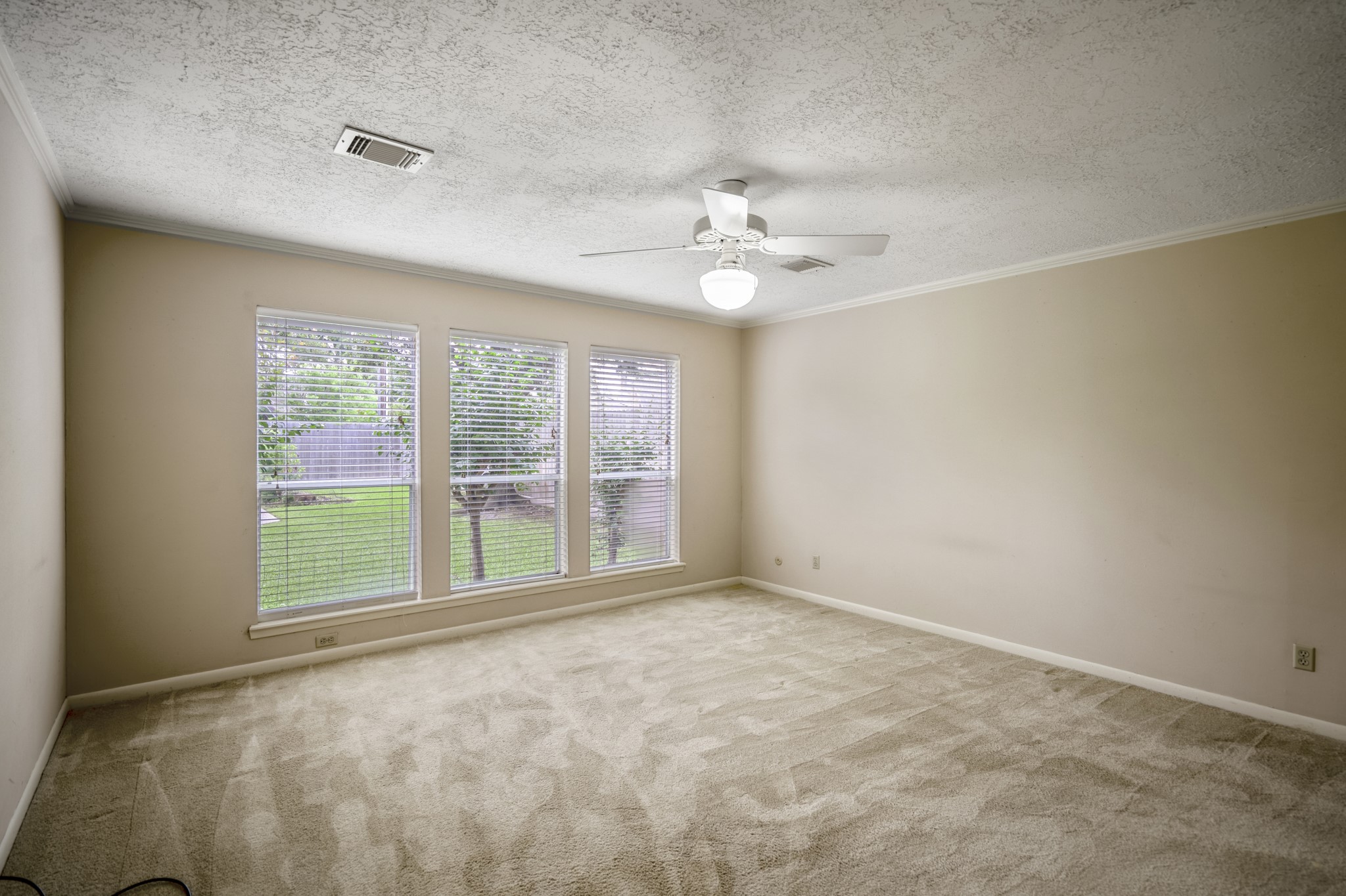 16606 Brendon Court Spring, TX 77379 - Photo 26 of 43 The primary suite offers wonderful views of the backyard, has neutral tones and has plenty of room for large bedroom furniture.