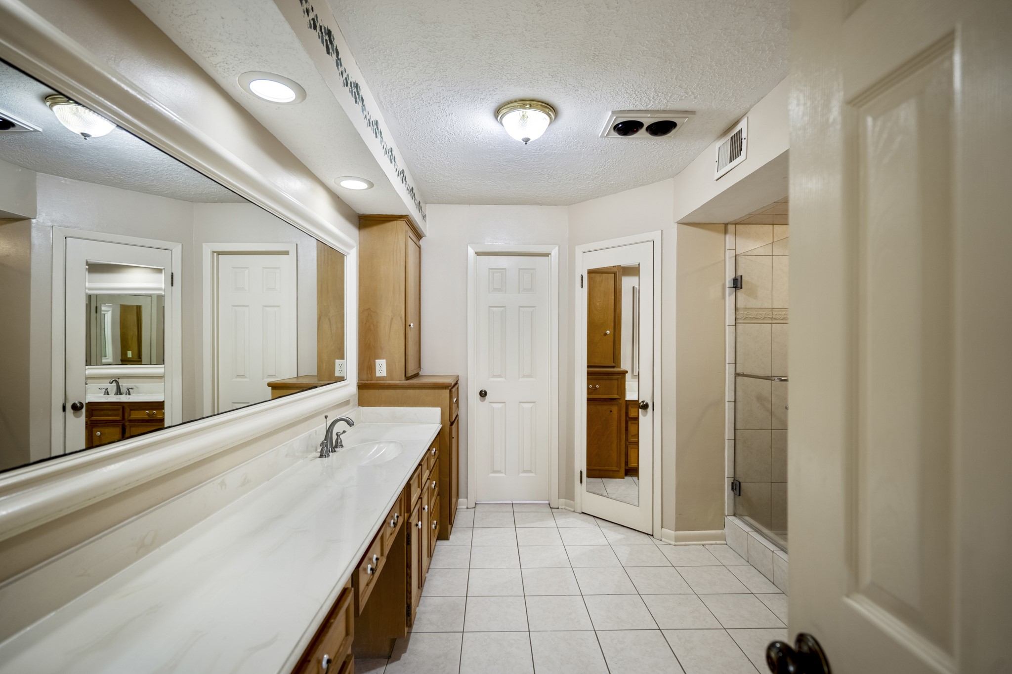 16606 Brendon Court Spring, TX 77379 - Photo 28 of 43 The en-suite bathroom has a large vanity area with overhead lighting, tiled floors and separate shower.