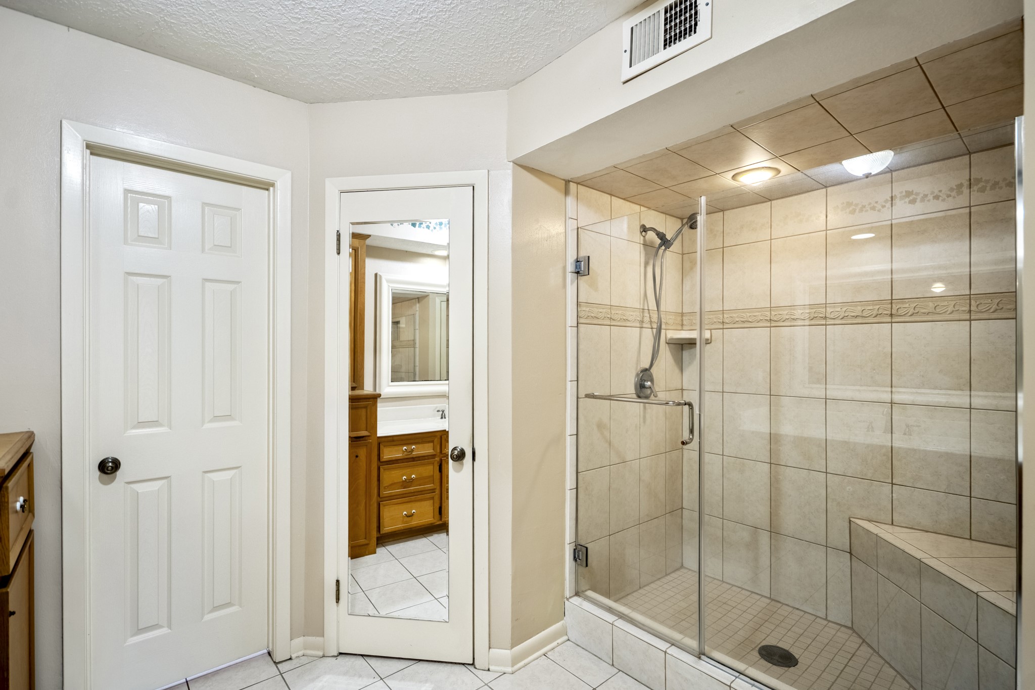 16606 Brendon Court Spring, TX 77379 - Photo 29 of 43 The glass enclosed shower has a seat and is tiled.