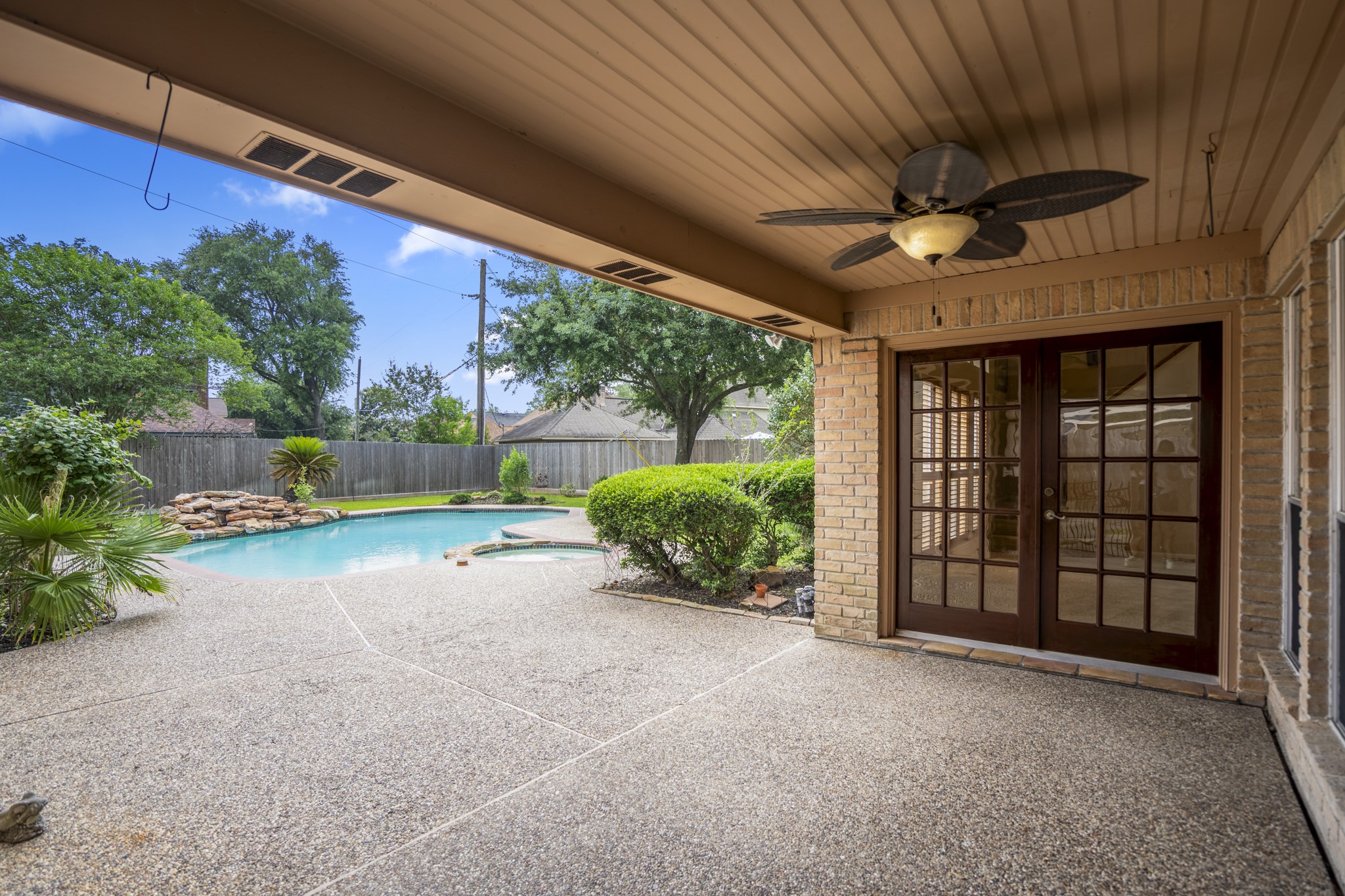 16606 Brendon Court Spring, TX 77379 - Photo 35 of 43 AS you step outside you have a large, covered patio that extends out towards the pool, plenty of room for several seating and sunning area.
