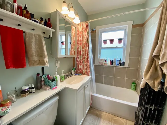 a bathroom with a bathtub a sink and a shower