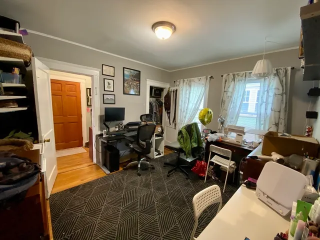 a living room with furniture a window and gym equipment