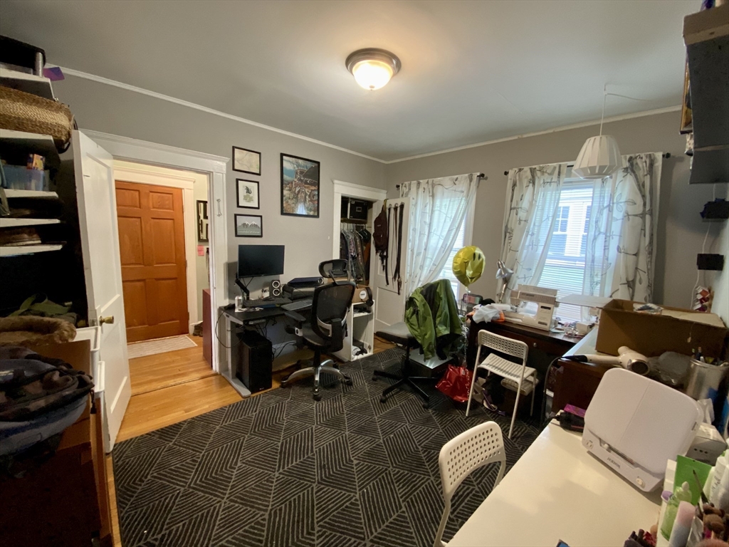 12 St Peter Street, Unit 1 Boston, MA 02130 - Photo 13 of 20 a living room with furniture a window and gym equipment