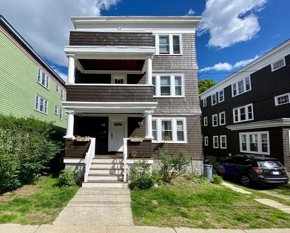 a front view of a house with a yard