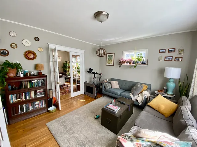 a living room with furniture and a bookshelf