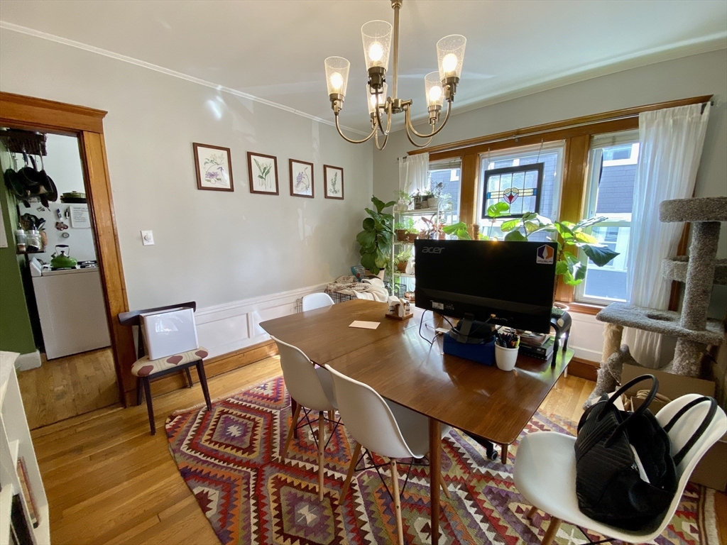 12 St Peter Street, Unit 1 Boston, MA 02130 - Photo 5 of 20 a living room with furniture a dining table and a flat screen tv