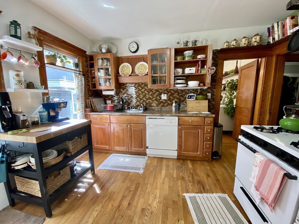 12 St Peter Street, Unit 1 Boston, MA 02130 - Photo 8 of 20 a kitchen with stainless steel appliances granite countertop a stove and a wooden floors