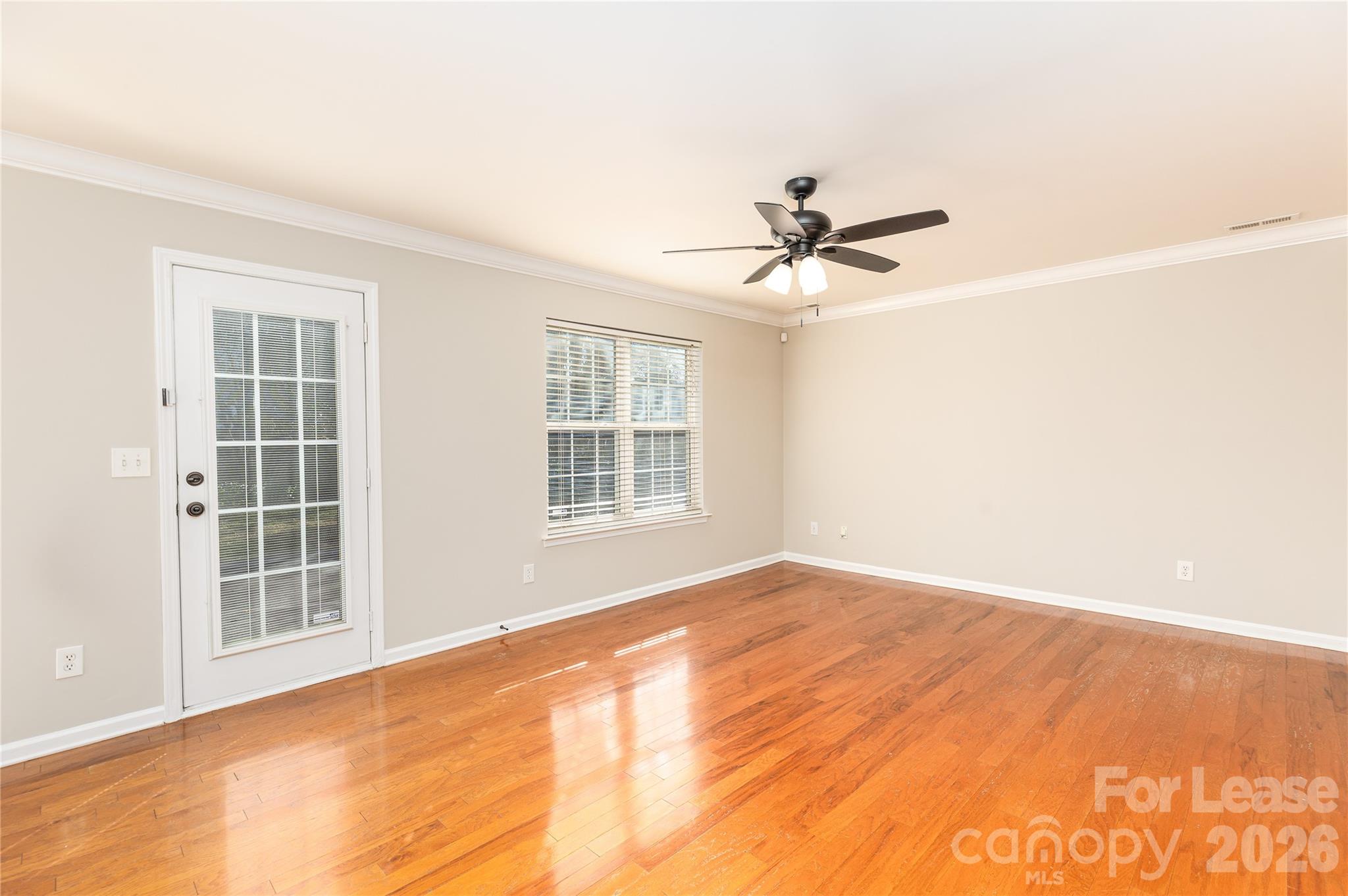 9724 Steele Meadow Road Charlotte, NC 28273 - Photo 12 of 38 an empty room with windows and fan