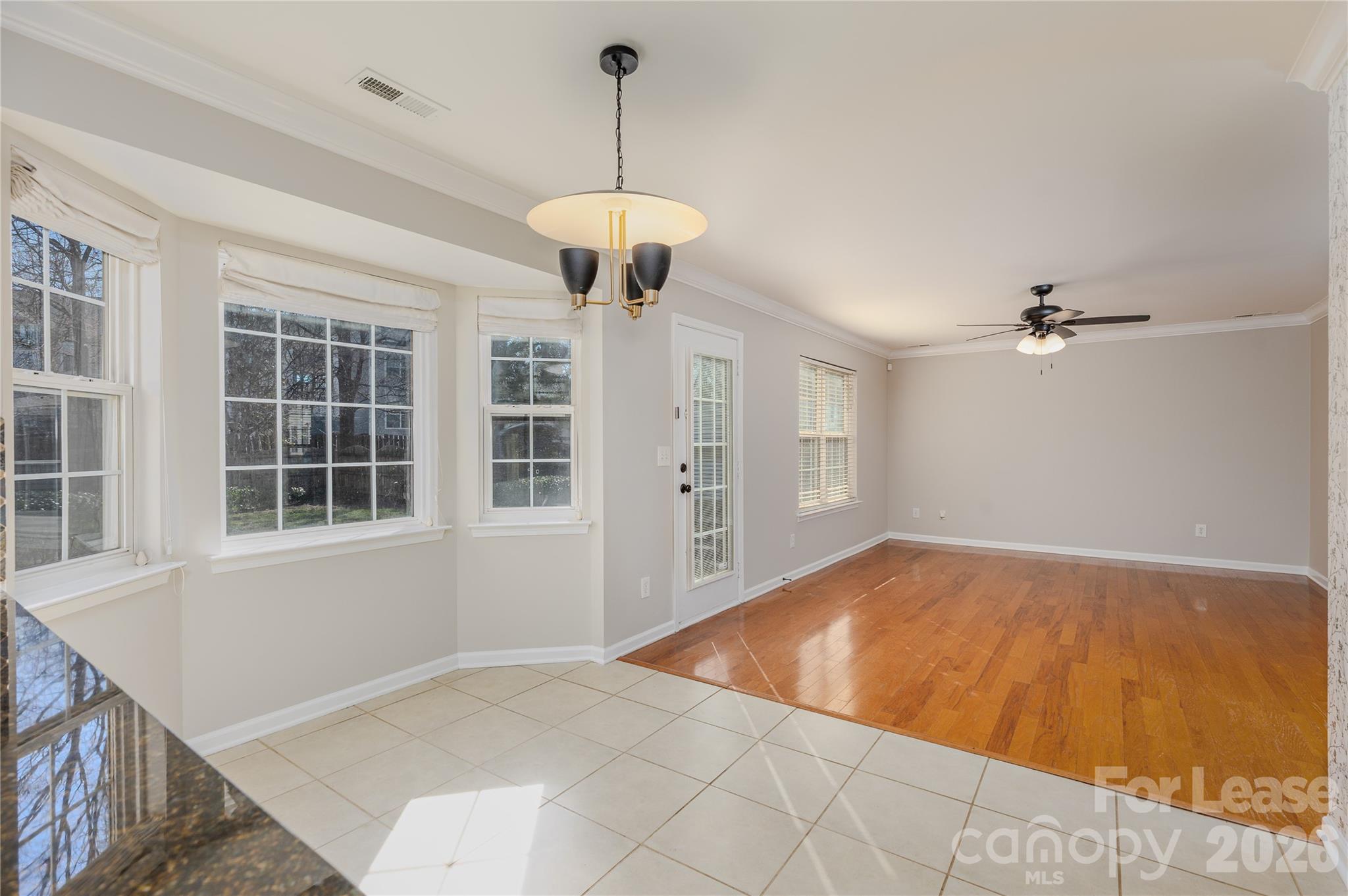 9724 Steele Meadow Road Charlotte, NC 28273 - Photo 15 of 38 a view of an empty room with a window and a chandelier