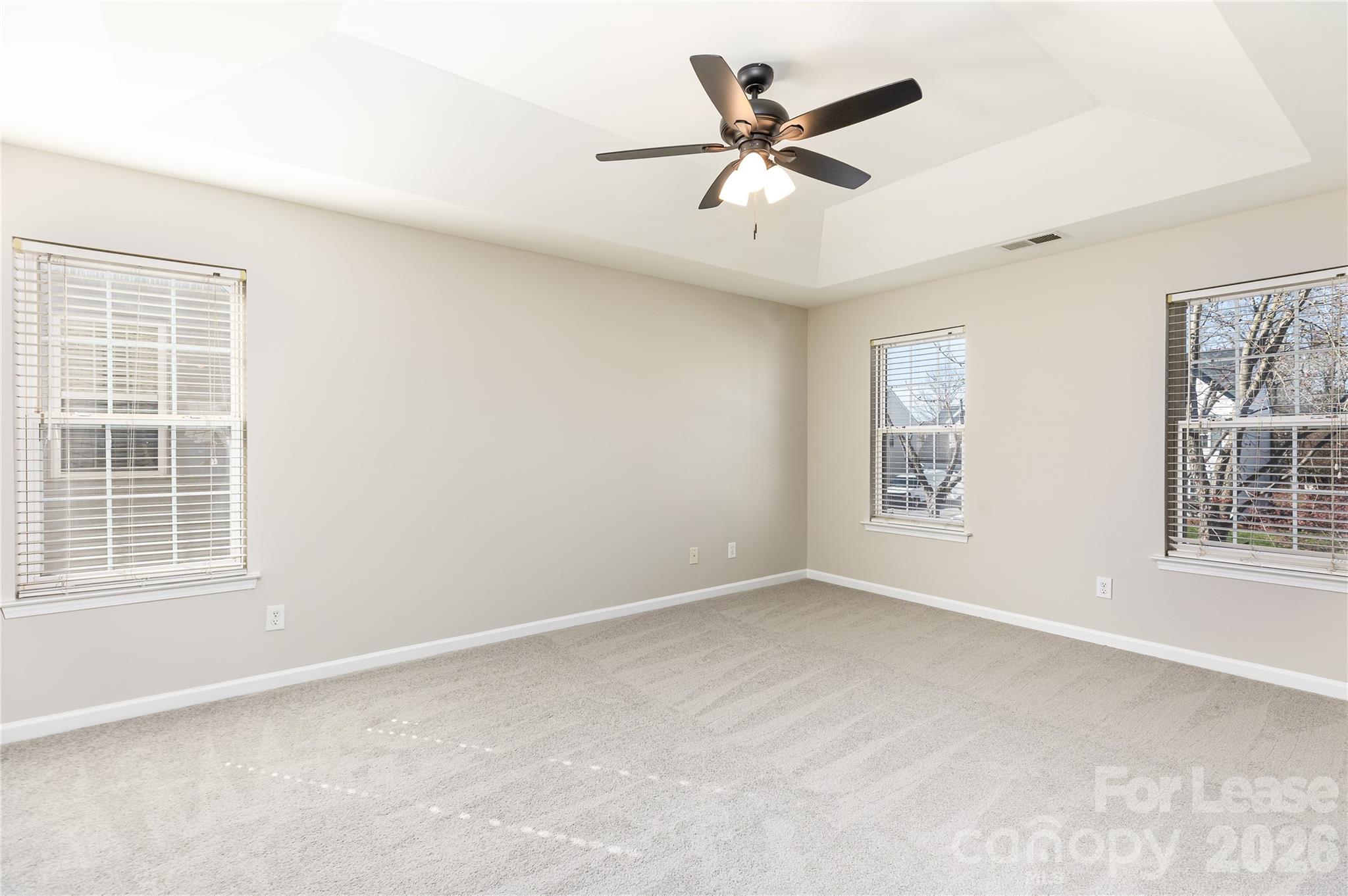 9724 Steele Meadow Road Charlotte, NC 28273 - Photo 26 of 38 an empty room with windows and fan